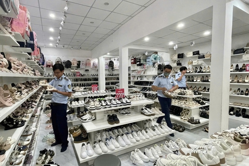 Lực lượng quản lý thị trường kiểm tra một cửa hàng kinh doanh giày dép trên địa bàn. Ảnh: QLTT