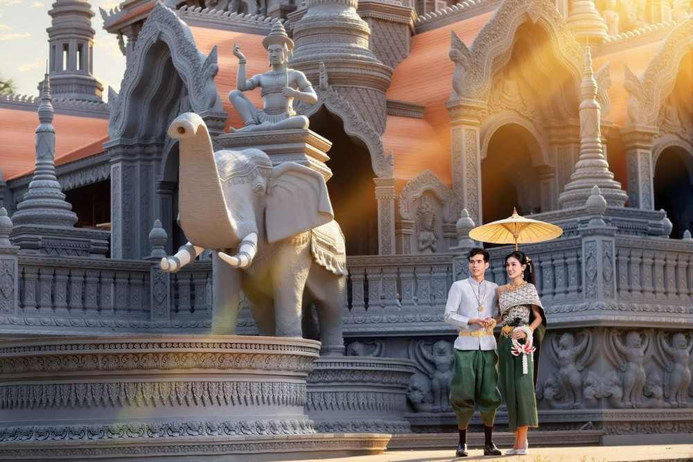 Trong ngày vui trọng đại, chú rể thường khoác lên mình chiếc áo cổ đứng uy nghi, rực rỡ và quấn K’bên (một mảnh vải dài được quấn quanh eo, luồn qua hai chân và giắt lên thắt lưng tạo thành hình dáng như chiếc quần thụng ngắn). Cô dâu lại càng kiêu sa hơn với áo ngắn tay hoặc dài tay ôm sát, kết hợp cùng váy Som-pốt Hôl hoặc cũng quấn K’bên. (Ảnh: Chú Râu) Trong ngày vui trọng đại, chú rể thường khoác lên mình chiếc áo cổ đứng uy nghi, rực rỡ và quấn K’bên (một mảnh vải dài được quấn quanh eo, luồn qua hai chân và giắt lên thắt lưng tạo thành hình dáng như chiếc quần thụng ngắn). Cô dâu lại càng kiêu sa hơn với áo ngắn tay hoặc dài tay ôm sát, kết hợp cùng váy Som-pốt Hôl hoặc cũng quấn K’bên. (Ảnh: Chú Râu)